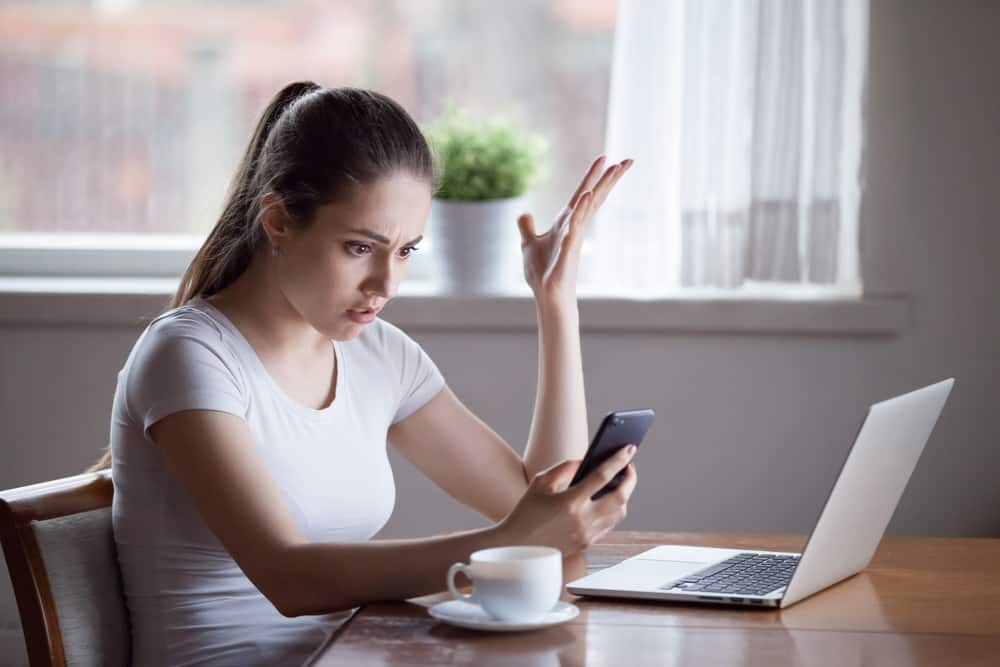 Mad woman annoyed by having problems with smartphone wondering Why Does He Keep Me Around If He Doesn't Want A Relationship?