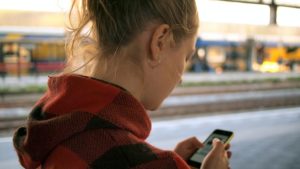 girl using her phone checking social media